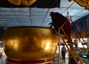 Monk Donating to Giant Alms Bowl Monk Donating to Giant Alms Bowl, Two Days in Bagan and Mount Popa, Myanmar